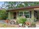 Inviting front porch with decorative flower pots, a bench, and unique brick archway at 8102 Fort Dade Ave, Brooksville, FL 34601