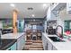 Open kitchen with marble countertops, a black farmhouse sink, and gray cabinets at 8102 Fort Dade Ave, Brooksville, FL 34601