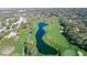 Aerial view of a lush golf course with a long lake and manicured lawns at 8132 Summersong Ct, Spring Hill, FL 34606