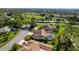 Aerial view showing the property with a screened-in pool in a golf course community at 8132 Summersong Ct, Spring Hill, FL 34606