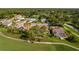 Aerial view of homes within a golf course community; some with screened in pools at 8132 Summersong Ct, Spring Hill, FL 34606