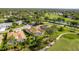 Aerial view showcasing the property, a screened-in pool, and the surrounding golf course community at 8132 Summersong Ct, Spring Hill, FL 34606