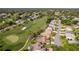 Aerial view of property on golf course with pool and screened in lanai and mature landscaping at 8132 Summersong Ct, Spring Hill, FL 34606