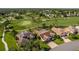 Aerial view of home next to a manicured golf course with mature trees at 8132 Summersong Ct, Spring Hill, FL 34606
