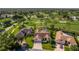 Aerial view of a home on a lush lot bordering a golf course with mature landscaping at 8132 Summersong Ct, Spring Hill, FL 34606