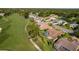 Aerial view of the neighborhood, golf course, and surrounding landscape at 8132 Summersong Ct, Spring Hill, FL 34606