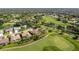 An aerial view of a community located on a golf course with ponds and tree-lined streets at 8132 Summersong Ct, Spring Hill, FL 34606