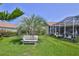 Relaxing backyard featuring a covered lanai and seating area, perfect for enjoying the outdoors at 8132 Summersong Ct, Spring Hill, FL 34606