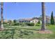 A charming home featuring a screened lanai overlooking a landscaped yard with lush green grass at 8132 Summersong Ct, Spring Hill, FL 34606