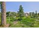 Spacious backyard, enhanced by a bench, mature trees, and lush landscaping at 8132 Summersong Ct, Spring Hill, FL 34606