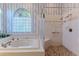 Bathtub and stand-up shower combination with tiled enclosure at 8132 Summersong Ct, Spring Hill, FL 34606