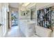 Bathroom featuring white tiled floor, walk-in access to pool, white cabinets and unique fish themed shower curtain at 8132 Summersong Ct, Spring Hill, FL 34606