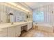 Bathroom featuring a large vanity with dual sinks, a soaking tub and a stand-up shower at 8132 Summersong Ct, Spring Hill, FL 34606