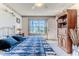Bedroom featuring a bed with a blue comforter and view of a the golf course through the window at 8132 Summersong Ct, Spring Hill, FL 34606