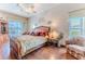 Comfortable primary bedroom with decorative wall features and a view to the pool at 8132 Summersong Ct, Spring Hill, FL 34606