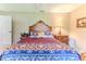 Bedroom featuring a large bed with a decorative headboard and a nightstand with a lamp at 8132 Summersong Ct, Spring Hill, FL 34606