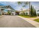 Exterior angle of a clubhouse features a covered entry and tall trees in a landscaped yard at 8132 Summersong Ct, Spring Hill, FL 34606