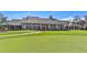 A golf clubhouse with a veranda and many windows overlooking the course at 8132 Summersong Ct, Spring Hill, FL 34606