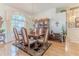 Charming dining room with a large window, hardwood floors, and a classic china cabinet at 8132 Summersong Ct, Spring Hill, FL 34606