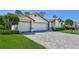 Lovely single-story home featuring a two-car garage, pavers, and a well-maintained lawn at 8132 Summersong Ct, Spring Hill, FL 34606