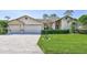 Charming single-story home with a well-manicured lawn, beautiful pavers, and a two-car garage at 8132 Summersong Ct, Spring Hill, FL 34606