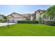 The home features a well-manicured front lawn and is accented by trimmed hedges at 8132 Summersong Ct, Spring Hill, FL 34606