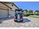 Rear view of red golf cart, complete with golf clubs, parked in driveway of a beige home at 8132 Summersong Ct, Spring Hill, FL 34606