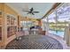A screened-in lanai with dining and lounge seating overlooks the pool and golf course at 8132 Summersong Ct, Spring Hill, FL 34606