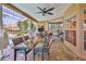 The lanai features a ceiling fan, dining table, and tile flooring for indoor/outdoor living at 8132 Summersong Ct, Spring Hill, FL 34606