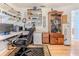 Cozy office area featuring hardwood floors, built-in shelving, and a comfortable chair at 8132 Summersong Ct, Spring Hill, FL 34606