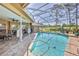 A screened-in pool with a lounging area, seating, and a water feature is the perfect space at 8132 Summersong Ct, Spring Hill, FL 34606