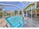 A beautiful screened-in pool with lounge seating offers the perfect spot to relax at 8132 Summersong Ct, Spring Hill, FL 34606