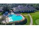 Aerial view of a community swimming pool with lounge chairs and manicured landscaping at 8132 Summersong Ct, Spring Hill, FL 34606