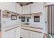 Indoor wet bar with white cabinets, and under cabinet lighting at 8132 Summersong Ct, Spring Hill, FL 34606