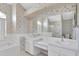 Bathroom with dual sinks, large mirror, soaking tub, and separate glass shower at 8228 Coral Creek Loop, Hudson, FL 34667