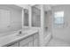 Bright bathroom includes a single vanity, large mirror, and shower-tub combo at 8228 Coral Creek Loop, Hudson, FL 34667