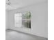 Bright bedroom featuring a large window and neutral walls with ceiling fan at 8228 Coral Creek Loop, Hudson, FL 34667