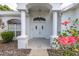 Inviting front entrance with classic white pillars and a decorative door at 8228 Coral Creek Loop, Hudson, FL 34667