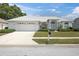 Charming single-story home with a well-manicured lawn and an attached two-car garage at 8228 Coral Creek Loop, Hudson, FL 34667