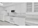 Well-lit kitchen equipped with modern white appliances and ample cabinet space for storage at 8228 Coral Creek Loop, Hudson, FL 34667