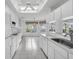 Spacious white kitchen with a skylight, leading to a bright breakfast nook area at 8228 Coral Creek Loop, Hudson, FL 34667