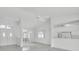 Open-concept living area with tile floors, neutral walls, and views into the adjacent kitchen space at 8228 Coral Creek Loop, Hudson, FL 34667