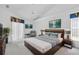 Modern main bedroom with a vaulted ceiling, neutral colors, contemporary decor, and a king bed at 8228 Coral Creek Loop, Hudson, FL 34667