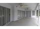 Spacious covered patio with dual ceiling fans and sliding glass doors, perfect for outdoor relaxation and entertainment at 8228 Coral Creek Loop, Hudson, FL 34667