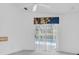 View of outdoor patio and pool through sliding glass doors with vertical blinds at 8228 Coral Creek Loop, Hudson, FL 34667