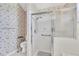 Bathroom featuring glass enclosed shower with a handheld shower wand and safety bar at 8228 Coral Creek Loop, Hudson, FL 34667