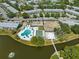 A vibrant aerial view showcases the pool, recreation center, and lake within a residential community at 8405 112Th St # 103, Seminole, FL 33772