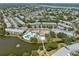 An aerial view shows a desirable community with lake, pool, recreational center and multiple residential buildings at 8405 112Th St # 103, Seminole, FL 33772