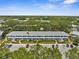 A sunny aerial view of a multi-unit residential building with parking and landscaped grounds at 8405 112Th St # 103, Seminole, FL 33772