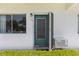 Exterior shot of the front door and window, with clean paint and minimal landscaping at 8405 112Th St # 103, Seminole, FL 33772